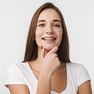 Woman smiling with bracket and wire braces