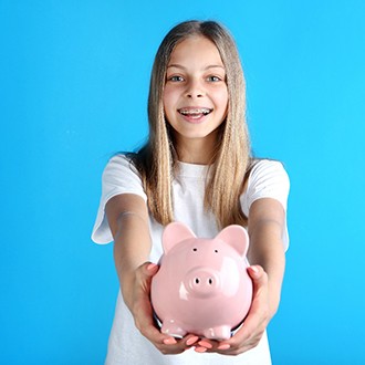 girl with piggy bank to cover cost of traditional braces  