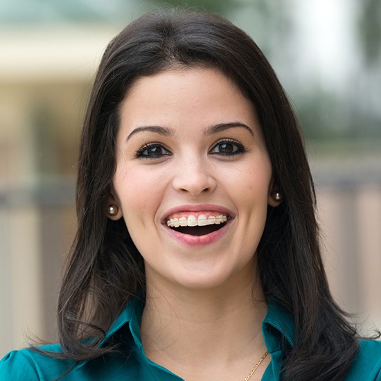 Smiling woman with clear and ceramic braces