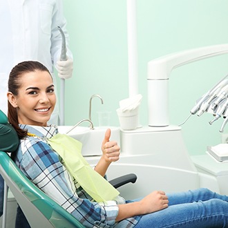 a dental patient giving a thumbs up