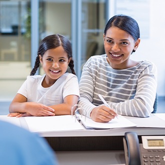 Mother and daughter checking in at orthodontist's office