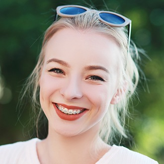 Young woman with braces smiling