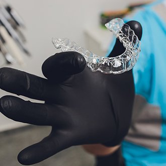 Hopkinton orthodontist holding up clear aligner