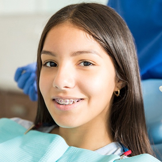 Teen with braces smiling at orthodontic appointment