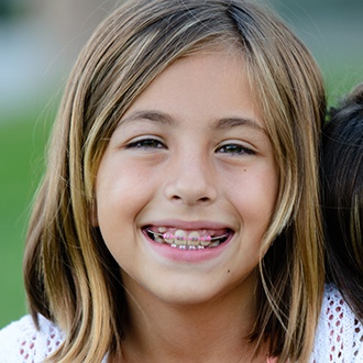 Young girl with pediatric orthodontic treatment smiling
