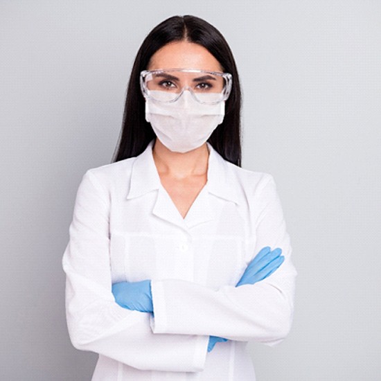 Hopkinton orthodontist with crossed arms facemask on white background