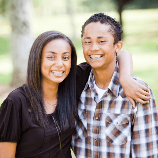 Two teens with braces smiling