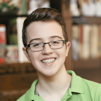 Preteen boy with braces smiling