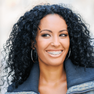 Woman with clear and ceramic braces smiling