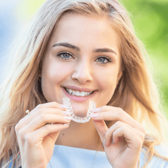 Woman placing an Invisalign tray