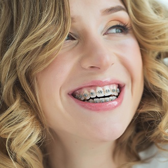 Closeup of smiling woman with traditional braces