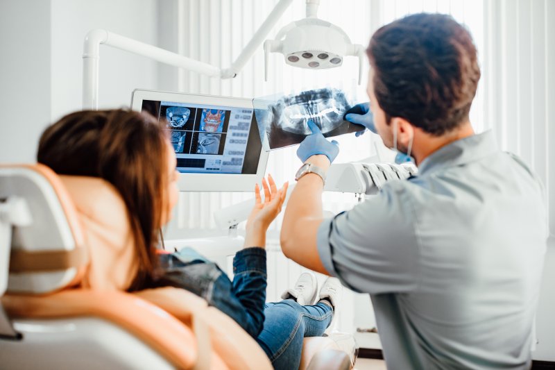 Orthodontist showing patient X-ray