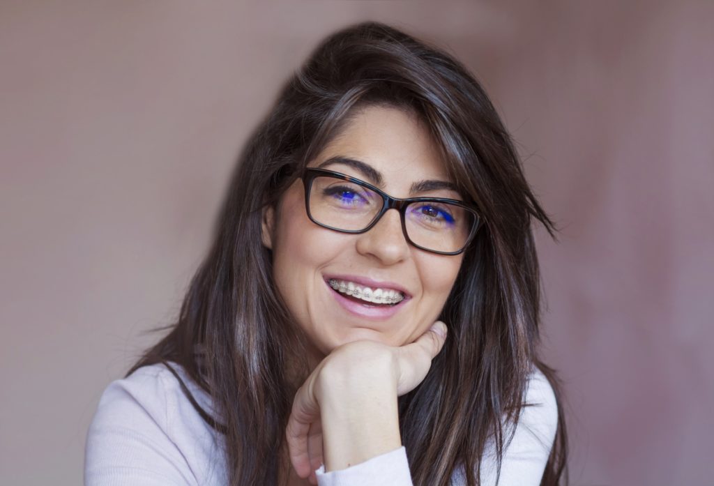 Mature woman with dental braces smiling