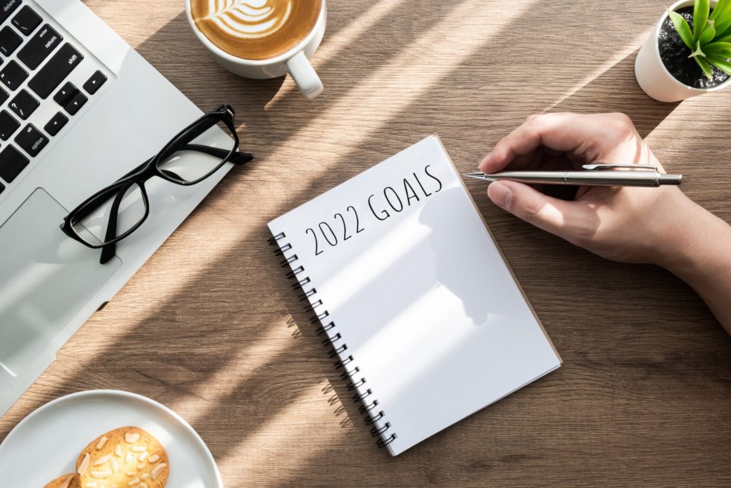 Patient writing New Year's resolutions at desk