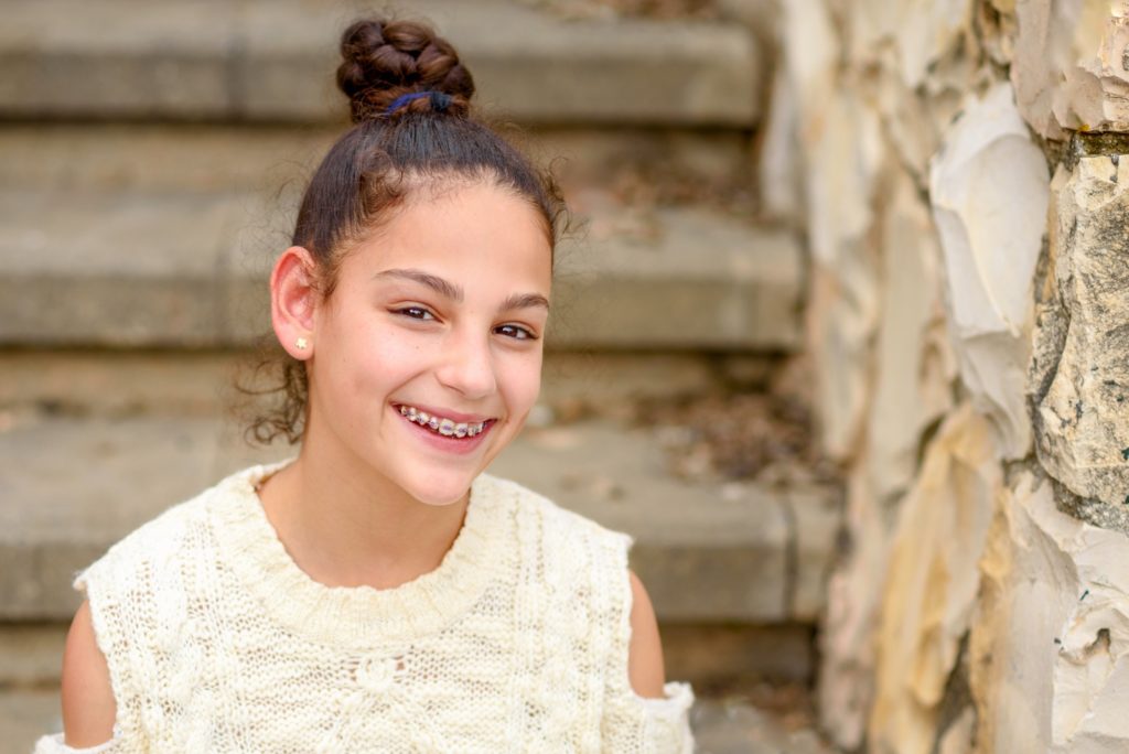 Closeup of young girl smiling with braces