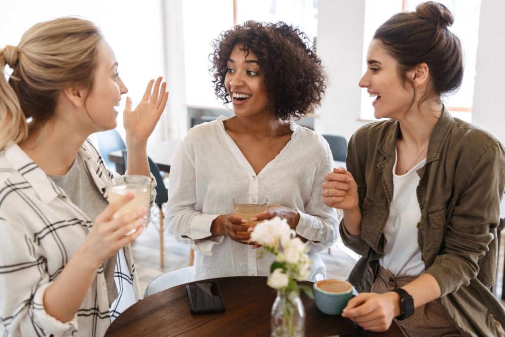 Group of girlfriends talking over coffee