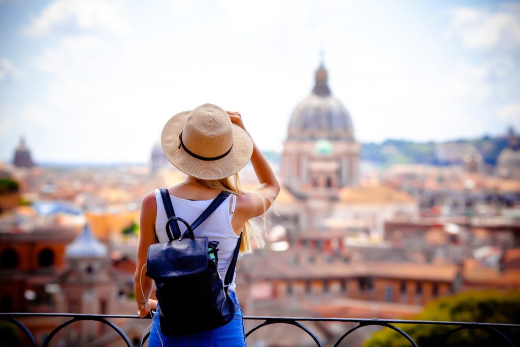 Woman with straw hat sightseeing in Europe