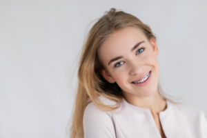 a patient with braces smiling 